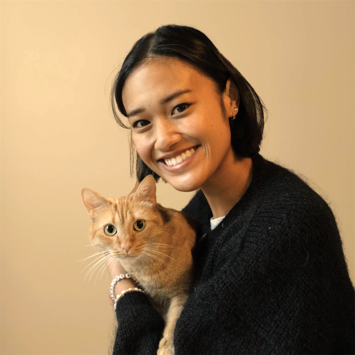 Dr. Ly holding her orange cat